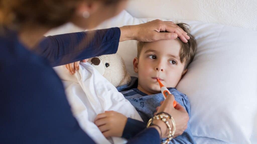 Mom and toddler with thermometer reduce toddler fever naturally
